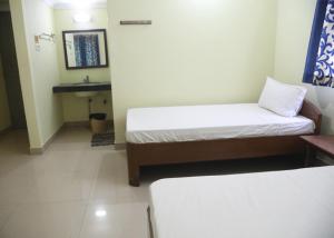 A bed or beds in a room at Geetha Residency