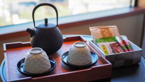 a tea set on a table with a tea pot at Sora Niwa Terrace Kyoto Bettei in Kyoto