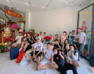 a group of people posing for a picture in a room at Dawn Villa Homestay Hội An in Hoi An
