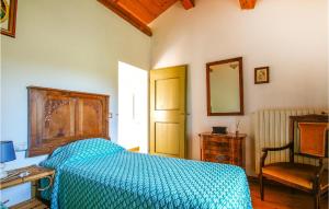a bedroom with a bed and a chair and a mirror at Cozy Home In Trebbiantico Di Pesaro With House A Panoramic View in Trebbiantico