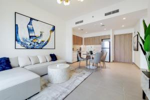 a living room with a white couch and a table at Primestay - Executive Residences in Dubai Hills Estate in Dubai