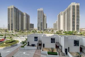 a view of a building in front of tall buildings at Primestay - Executive Residences in Dubai Hills Estate in Dubai