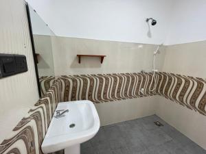 a bathroom with a sink and a mirror at Funky Sol - Sunset Rooftop Bar, Hotel & Restaurant in Weligama