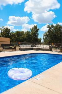 a swimming pool with a white object in the water at Son's Rio Cibolo - Glamping Cabin #J Romantic Getaway on Gorgeous Cibolo Creek! in Marion