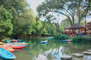 a group of boats in a river with a gazebo at Son's Rio Cibolo - Glamping Cabin #J Romantic Getaway on Gorgeous Cibolo Creek! in Marion