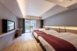 Postel nebo postele na pokoji v ubytování Minakami Onsen Aratashi Minakami + 37 fotografií