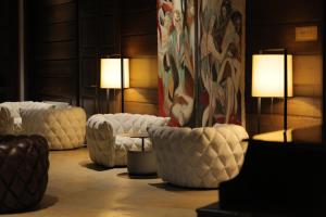 a living room with white couches and two lamps at Marco Polo Hotel Gudauri in Gudauri