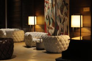 a living room with white couches and two lamps at Marco Polo Hotel Gudauri in Gudauri