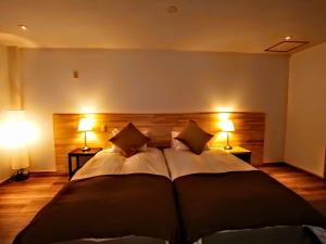 A bed or beds in a room at Fujio Pension Madarao Residence room & Restaurant