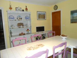 a dining room with a white table and pink chairs at Maison Monica Exeptionnel-Jardin paysage ZEN in Coursan +14 photos