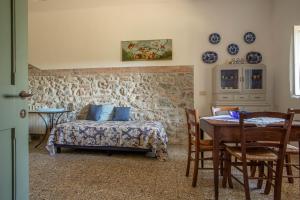 1 dormitorio con 1 cama, mesa y sillas en Manuela - Agriturismo La Valentina en Talamone