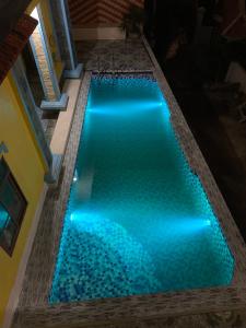 a swimming pool with blue lights in a house at Pra-Ha Villa in Tam Ðảo