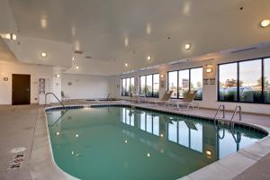 a large swimming pool in a building with windows at Holiday Inn Express Peru-Lasalle Area by IHG in Peru