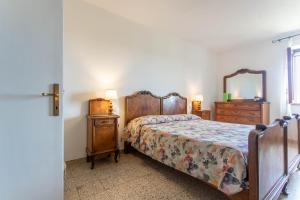 a bedroom with a bed and a dresser and a mirror at Enrica - Agriturismo La Valentina in Talamone