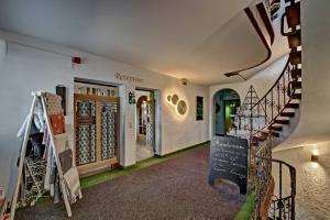 a shop with a staircase and a store with wine racks at Allgäuer Panoramahotel in Oberstaufen