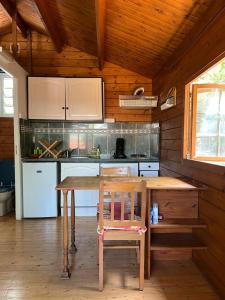 a wooden kitchen with a wooden table and a chair at L'Ilot Zoizeaux in Les Avirons