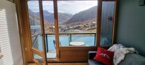 a room with a window with a view of a mountain at Le 1888 Val d'Isère in La Daille