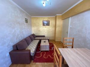 a living room with a couch and a table at Apartman Centar in Zlatibor