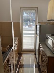 a kitchen with a window and a sink and a microwave at Apartman Centar in Zlatibor