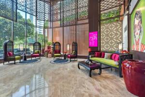 a lobby with a couch and chairs in a building at Ashley Tang Menteng Jakarta in Jakarta