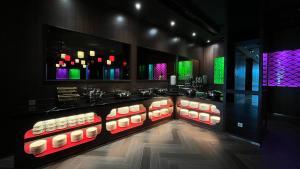 a bar with a display of sushiaminesaminesktop at Ashley Tang Menteng Jakarta in Jakarta