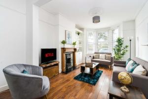 a living room with a couch and a fireplace at Edridge Lodge Photo ID & Deposit Required in Croydon