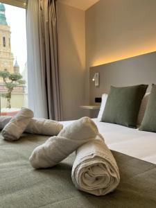 ein Handtuch auf einem Bett in einem Hotelzimmer in der Unterkunft AZ Hotel San Valero in Saragossa