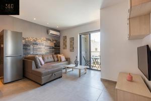 a living room with a couch and a tv at High-End central APT with comfy BED & Super WIFI by 360 Estates in San Ġwann