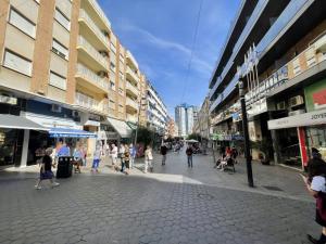 a group of people walking down a street in a city at Luxury Center Apartment in Benidorm