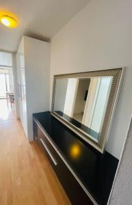 a mirror on top of a dresser in a room at Sunrise Studio für 2-3 Personen in Munich