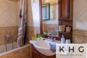 a bathroom with a sink and a mirror and a tub at Villa Elaionas 1 Experiencing nature's tranquility! in Svoronata +17 photos