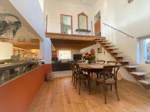 a dining room with a table and chairs and a staircase at Villa Elva in Le Plan-de-la-Tour