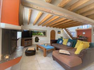 a living room with a couch and a fireplace at Villa Elva in Le Plan-de-la-Tour