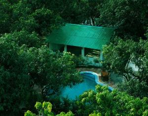 an overhead view of a house with a swimming pool at Hotel Holiday Highlights in Rāmnagar