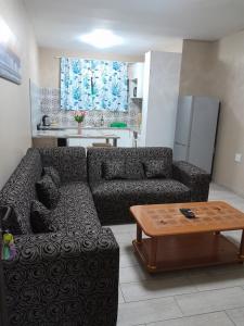 a living room with a couch and a coffee table at Margate Sunset Apartments in Margate