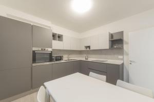 a kitchen with white cabinets and a white counter top at Da Nonna Antonia in Martellago