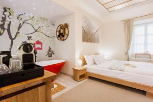 a bedroom with a bed and a bath tub at Dunakavics XIII Apartman in Szentendre +79 photos