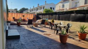 a patio with a table and chairs and plants at Zona5 Apartamentos Turísticos in El Vendrell