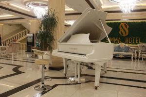 a white piano on display in a mall at Simma Hotel Spa & Waterpark in Tashkent