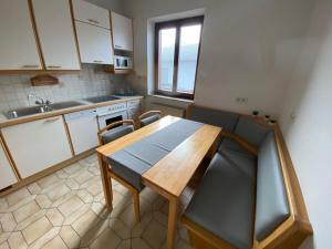 a kitchen with a wooden table and chairs at Apartment 2 Feistriz in Rosental 9181 in Feistritz im Rosental