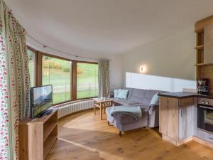 a living room with a couch and a tv at Ferienhaus Widmann in Kirchberg in Tirol