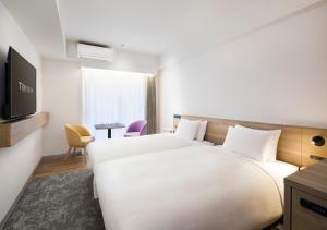 Postel nebo postele na pokoji v ubytování Tokyu Stay Shibuya Shin-Minamiguchi