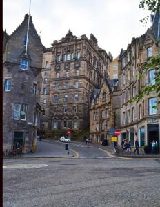 a street scene with cars and a building at The Inn Place in Edinburgh