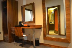 a bathroom with a vanity with a mirror and a chair at The Inn Place in Edinburgh