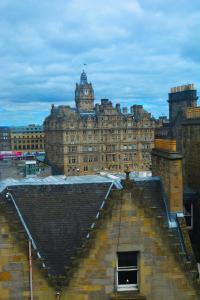 a large building with a clock tower on top of it at The Inn Place in Edinburgh