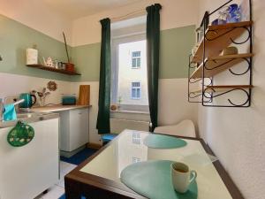 a kitchen with a table with a coffee cup on it at Appartement Buntspecht in Erfurt