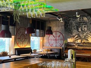 a restaurant with tables and chairs and chandeliers at Arctic Boutique Hotel Northcape in Honningsvåg