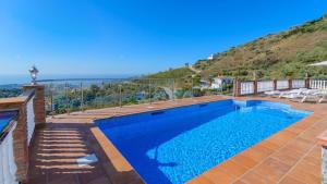 a swimming pool with a view of the ocean at Villa el Pedregal Frigiliana by Ruralidays in Frigiliana
