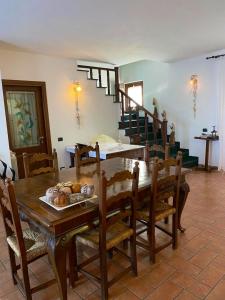 a dining room with a wooden table and chairs at 4 bedrooms house with lake view enclosed garden and wifi at Amelia in Amelia