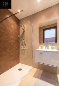 a bathroom with a shower and a sink at High-End central APT with comfy BED & Super WIFI by 360 Estates in San Ġwann